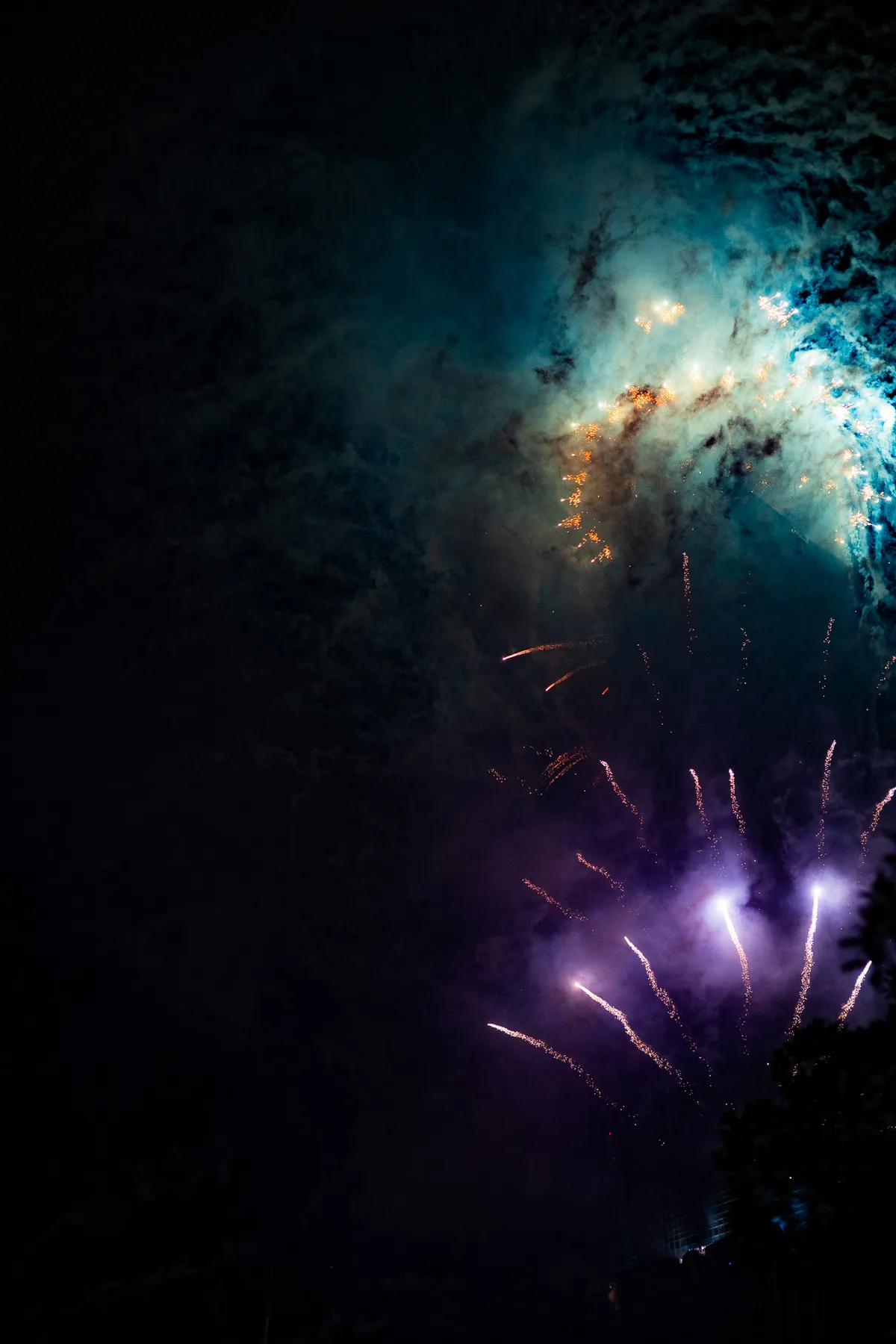 Fireworks bursting over a night cityscape